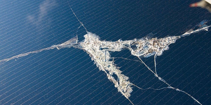 close-up of solar panel with crack in it